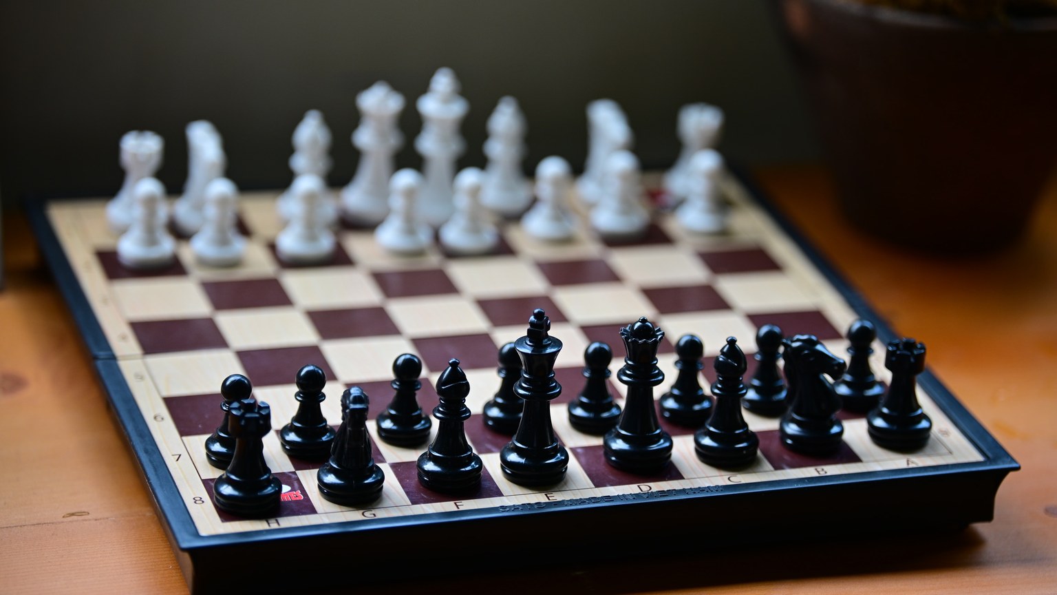 Chess board set with black and white pieces ready for a game. Perfect for strategy themes.