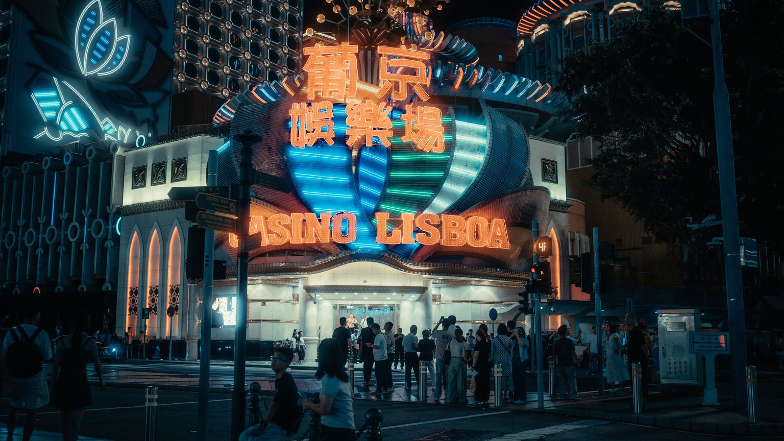 Explore the dazzling lights and vibrant nightlife at Casino Lisboa in Macao, capturing the essence of a bustling city.