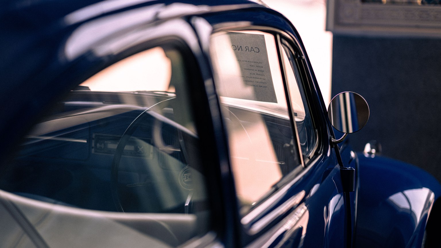 A classic blue vintage car with reflections, capturing an elegant retro style.